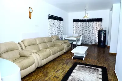 a living room with a couch and a table at HAILSTONE HOME STAY in Ooty