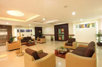 a large living room with couches and chairs at HOTEL SRIVATSA REGENCY in Pudunagaram