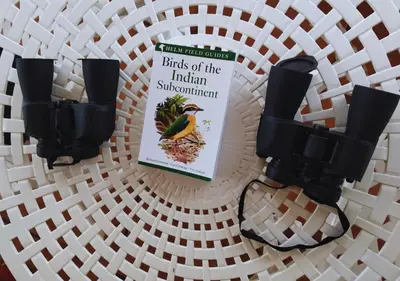 a book on birds of the indian subcontinent on a table at Wild Pastures by Nature Resorts and Stays in Masinagudi