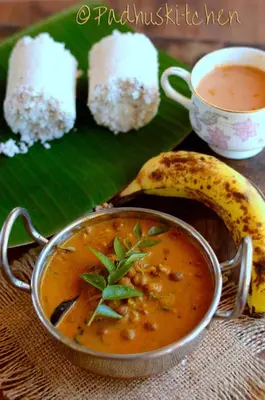 a plate of food with a bowl of soup and a banana at CITADEL HOLIDAY HOME in Vythiri