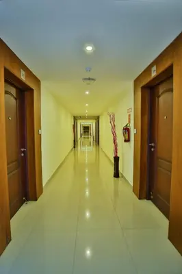 an empty hallway of a building with doors and a hallwayngth at Harbour Hotels in Pallipuram