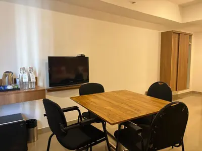 a conference room with a table and chairs and a tv at Hotel Mangala Temple View in Guruvāyūr