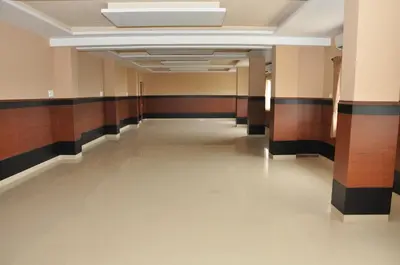 an empty hallway in a building with wooden walls and ceilings at Hotel Royal Chambers in Coimbatore