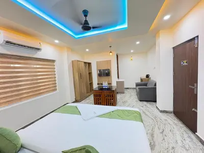 a room with a bed and a blue ceiling at Marhaba plaza in Kozhikode