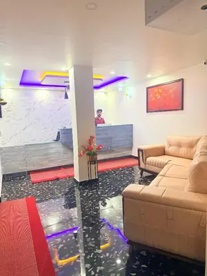 a living room with a fish tank in the floor at Marhaba plaza in Kozhikode