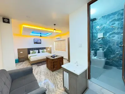 a living room with a bed and a bathroom at Marhaba plaza in Kozhikode