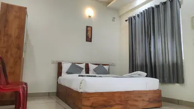 a bedroom with a bed and a black curtain at Homey Residency vythiri in Padinjarathara