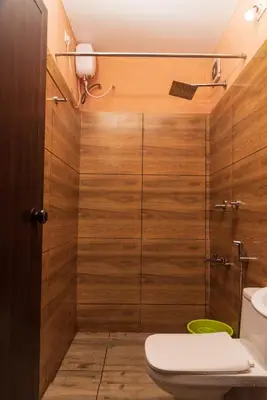 a bathroom with a toilet and a shower at treevillawayanad in Vythiri