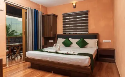 a bedroom with a bed with two swans on it at treevillawayanad in Vythiri