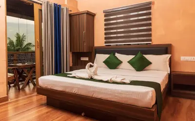a bedroom with a bed with two towels on it at treevillawayanad in Vythiri