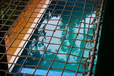 a view of the water from the inside of a cage at Cozy 3 BHK PoolVilla near Nagerhole National park. in Wayanad