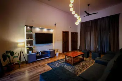 a living room with a couch and a table at Cozy 3 BHK PoolVilla near Nagerhole National park. in Wayanad