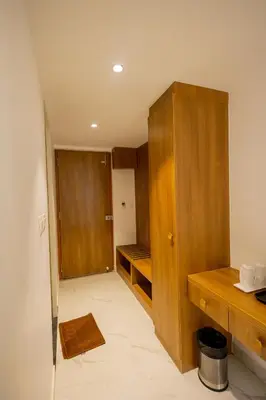 a room with a closet and a wooden cabinet at HOTEL VARDHA Inn in Bhavāni
