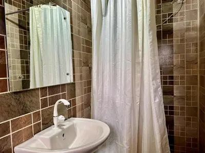 a bathroom with a sink and a shower curtain at The Wild Farms By Gwestai in Masinagudi