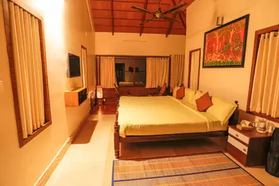 a bedroom with a bed in a room at Neelambari Ecotoursm in Trichūr