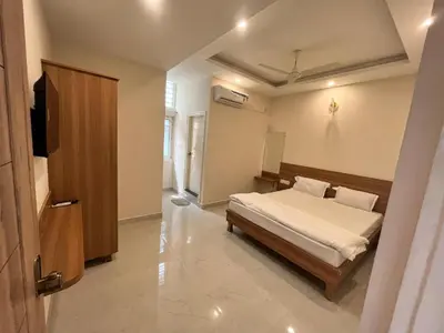a bedroom with a bed and a television in it at Seema Palace Inn 1 km from Railwaystaion in Mysore