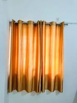 an orange shower curtain hanging on a wall at Soorya Madhavam Apartment Guruvayur - 200 m from temple walkable in Guruvāyūr