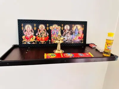 a shelf with a picture and a figurine on it at Soorya Madhavam Apartment Guruvayur - 200 m from temple walkable in Guruvāyūr
