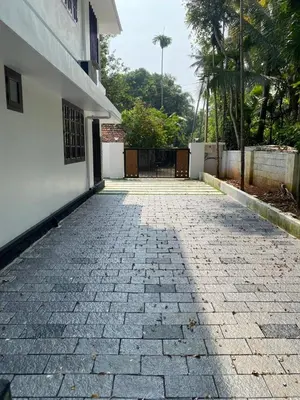 a stone walkway in front of a white building at Elegant RiverView Villa in Cochin