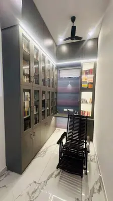 a room with a chair on a glass floor at Elegant RiverView Villa in Cochin