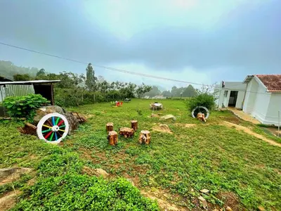 a yard with a group of animals in the grass at VERMONT HOMe STAY in Ooty