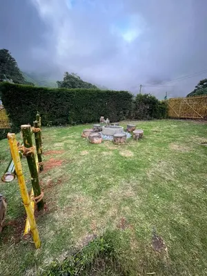 a garden with a fire pit in the grass at Sandy Holiday Home 5 Bhk in Ooty