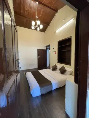 a bedroom with a large bed in a room at Sandy Holiday Home 5 Bhk in Ooty