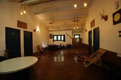 a large room with a table and chairs in it at The Green Casa By Green leaves -Families Only in Ooty