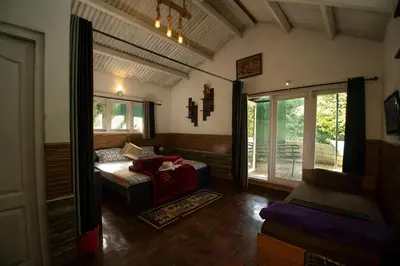 a living room with a couch and a window at The Green Casa By Green leaves -Families Only in Ooty