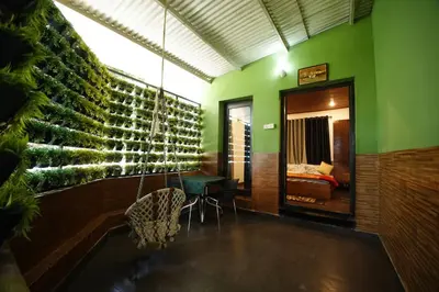a room with a green wall with a mirror at The Green Casa By Green leaves -Families Only in Ooty