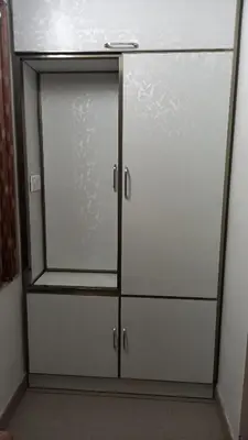 a closet with glass doors in a room at Niks home stay - A in Trichūr