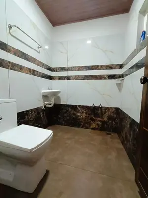 a bathroom with a toilet and a sink at Paradise Single Room in Wayanad