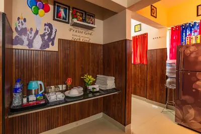 a room with a shelf with dishes on it at Sancta Maria Airport Hotel in Cochin