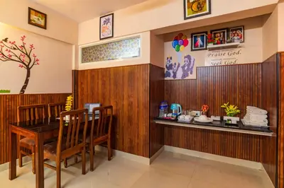 a restaurant with a table and chairs in a room at Sancta Maria Airport Hotel in Cochin