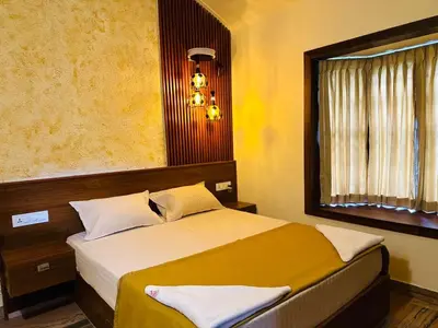 a bedroom with a bed and a window at The Mallika Holidays in Mananthavady