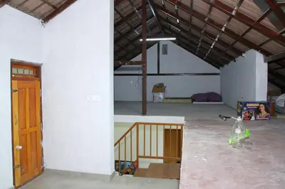 an empty garage with a room with a staircase in it at Airy Homestay Ooty by Lexstays in Ooty