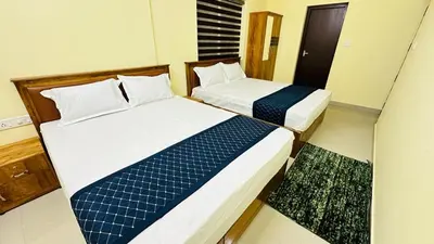 two beds sitting next to each other in a room at Mystique Inn Wayanad-vythiri in Vythiri