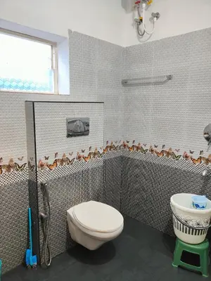 a bathroom with a toilet and a sink at Mystique Inn Wayanad-vythiri in Vythiri