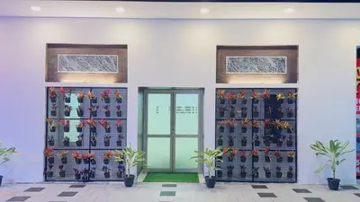 a building with a wall filled with wine bottles at Mystique Inn Wayanad-vythiri in Vythiri