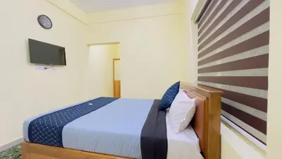 a bedroom with a bed with a american flag on the wall at Mystique Inn Wayanad-vythiri in Vythiri