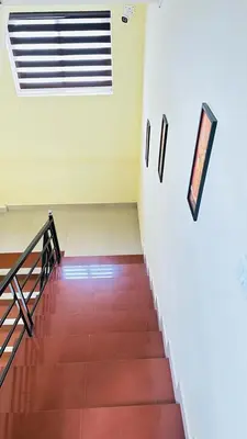 a hallway with a staircase in a building at Mystique Inn Wayanad-vythiri in Vythiri