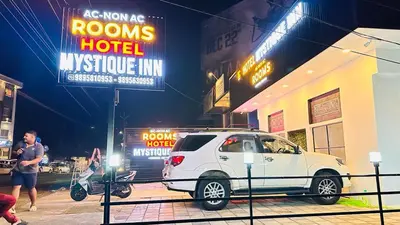 a white car parked in front of a hotel at Mystique Inn Wayanad-vythiri in Vythiri