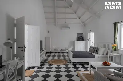 a living room with a couch and a checkered floor at Stayvista at Mudra Manor 4BR - Coffee Estate Comp Breakfast Big Heated Pool in Madikeri