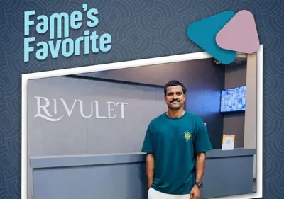 a man standing in front of a company logo at RIVULET HOTEL APARTMENTS in Mukkam