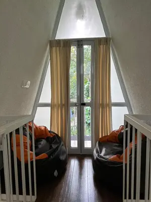 a room with two bean bags in front of a window at The Mallika Holidays - A Cabin in Mananthavady