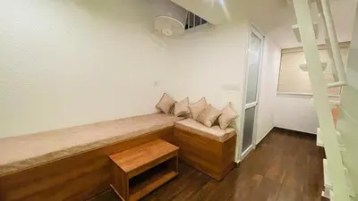 a couch with pillows on it in a room at The Mallika Holidays - A Cabin in Mananthavady