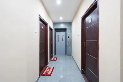 a hallway with two doors and a tile floor at AAFIYA LAKEVIEW APARTMENTS in Coimbatore