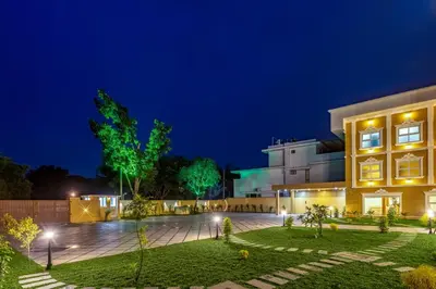 a building with a courtyard at night at ESAA Airport Hotel in Cochin