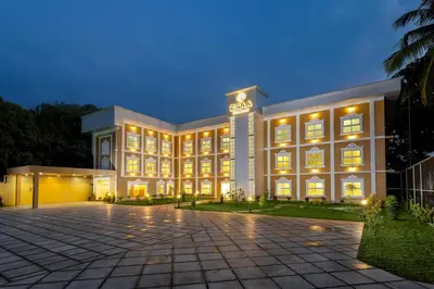 a large building with a lot of windows at night at ESAA Airport Hotel in Cochin