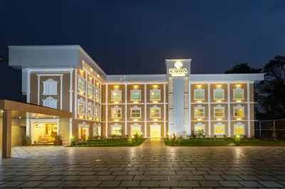 a large building with lights in the night at ESAA Airport Hotel in Cochin